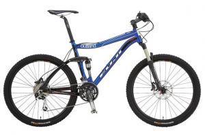 Fuji Outland Pro: Mountain bike with a blue and black frame, featuring wide tires, a front suspension fork, and disc brakes.