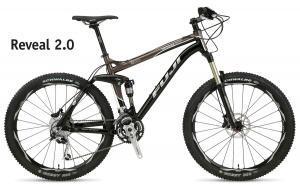 Fuji Reveal 2.0: A black and brown mountain bike, model Reveal 2.0, displayed against a white background. The bike features large wheels, front suspension, and a lightweight frame designed for off-road riding.