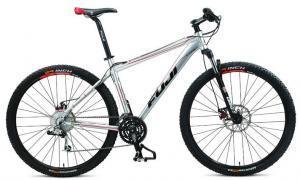 Fuji Tahoe 29 Comp: A silver mountain bike featuring a lightweight aluminum frame, disc brakes, and knobby tires designed for off-road riding. The bike has a modern design with red accents on the wheels and handlebars.