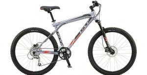 GT Avalanche 1.0 Disc: A silver and black mountain bike featuring a sturdy frame, wide tires, and a comfortable seat, designed for off-road riding.