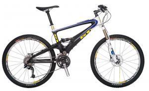 GT Marathon Carbon Team: A modern mountain bike featuring a black and white frame with blue accents, equipped with dual disc brakes, thick tires, and a suspension system, positioned against a plain background.