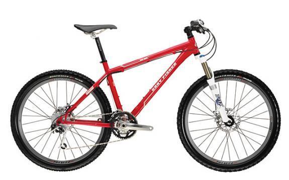Gary Fisher Big Sur: A red mountain bike with a lightweight frame, front suspension, and disc brakes. The bike features wide tires designed for off-road terrain and has a sleek design, making it suitable for outdoor cycling adventures.
