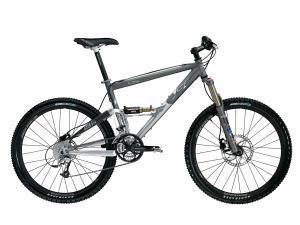 A gray mountain bike with large wheels, a full suspension system, and disc brakes, positioned on a plain background.