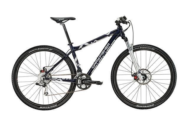 Gary Fisher Cobia: A mountain bike with a dark blue and silver frame, featuring thick tires, disc brakes, and a front suspension fork, positioned on a white background.