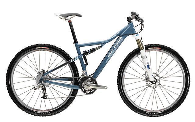 Gary Fisher HiFi Deluxe: A modern mountain bike with a sleek blue frame, featuring front suspension forks, a Shimano gear system, and wide tires designed for off-road trails. The bike is positioned against a neutral background, showcasing its design and components.