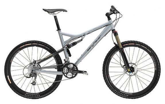 Gary Fisher HiFi Deluxe: A gray mountain bike with a suspension frame, equipped with disc brakes and knobby tires for off-road terrain. The bike features a sleek design with a prominent front fork and a comfortable saddle, ideal for biking enthusiasts.