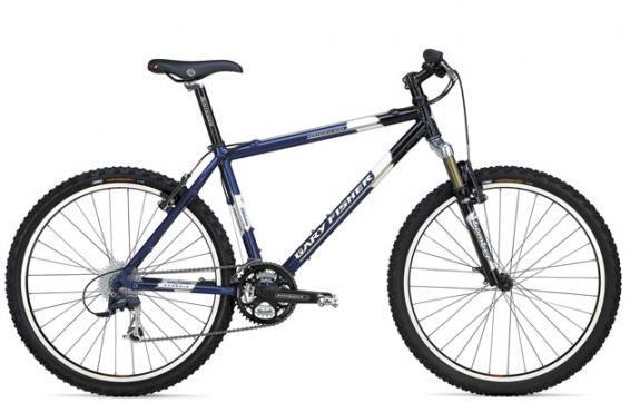 Gary Fisher Hoo Koo E Koo: A blue mountain bike with a lightweight frame, front suspension, and knobby tires. The bike features a gear system and a black seat, positioned at an angle for optimal riding comfort.