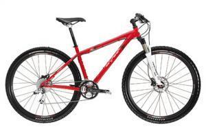 Gary Fisher Paragon: A red mountain bike with a lightweight frame, front suspension, and disc brakes, positioned against a white background.