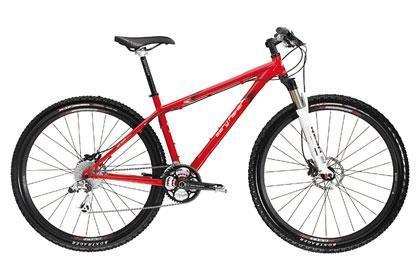 Gary Fisher Paragon: A red mountain bike with a lightweight frame, front suspension, and thick tires, designed for off-road cycling. It features disc brakes and a modern design ideal for outdoor adventures.