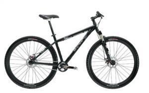 Gary Fisher Rig: A black mountain bike with a sturdy frame, front suspension, and thick tires, positioned against a white background.