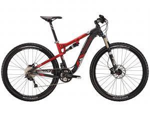 Trek Rumblefish: A red and black mountain bike with a sturdy frame and thick tires, designed for off-road cycling. The bike features a dual suspension system and prominent gears, highlighting its performance capabilities on rugged terrain.