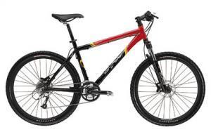 Gary Fisher Tassajara Disc: A modern mountain bike with a sleek black and red frame, featuring thick tires, a sturdy frame design, and front suspension forks, positioned against a plain white background.