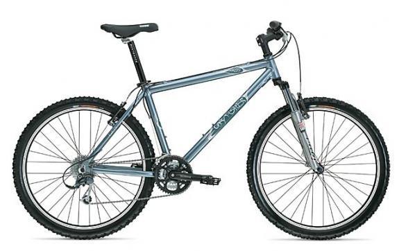 Gary Fisher Tassajara: A blue mountain bike with a lightweight aluminum frame, featuring dual suspension, a front fork, and knobby tires for traction. The bike has a comfortable seat, adjustable handlebars, and a gear system visible on the right side.