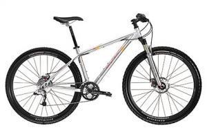 Gary Fisher X-Caliber: A silver mountain bike with a lightweight frame, front suspension, and black tires. The bike features disc brakes and a standard handlebar, suitable for off-road cycling.