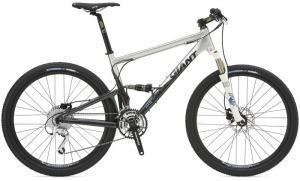 Giant Anthem 1: A modern mountain bike with a white and black frame, featuring front suspension, disc brakes, and knobby tires.