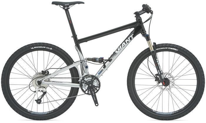 Giant Anthem 2: A mountain bike featuring a sleek design with a black and silver frame, front suspension, and disc brakes. The bike is equipped with rugged tires suitable for off-road terrains and displays branding from the manufacturer.