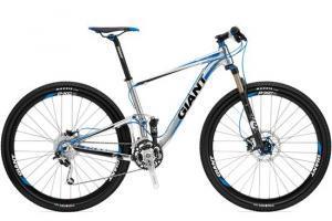 Giant Anthem X 29er 1: Mountain bike with a blue and silver frame, front suspension, and black tires. The bike features disc brakes and a lightweight design, suitable for off-road trails.