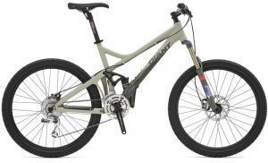 Giant Reign 0: A light green mountain bike with a dual suspension frame, featuring disc brakes, thick tires, and a gear shifter on the handlebars.