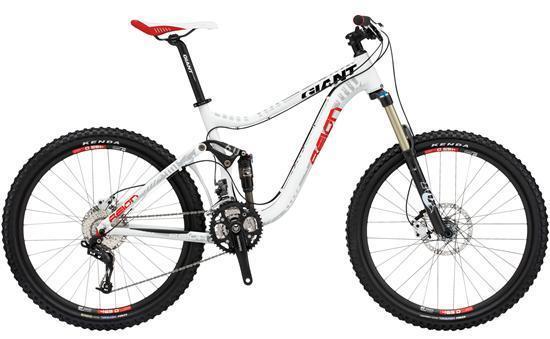Giant Reign 2: A white and red mountain bike with dual suspension, featuring oversized tires, disc brakes, and a performance-oriented design. The bike includes a prominent brand logo on the frame and is positioned against a neutral background.