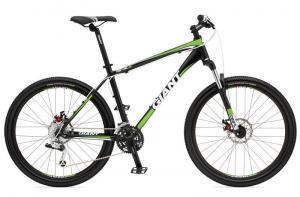 Giant Revel 0: A black and green mountain bike with a sturdy frame, featuring front suspension and large wheels. The bike is designed for off-road cycling, showcasing the brand name "Giant" prominently on the frame.