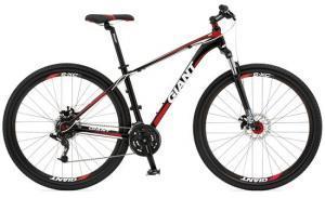 Giant Talon 29er: A black and red mountain bike with a lightweight frame, featuring disc brakes and wide tires suitable for off-road terrain. The bike has a prominent brand name "Giant" displayed on the frame.