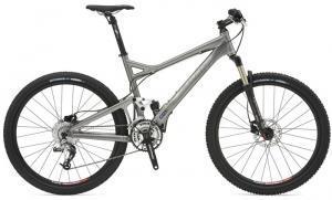 Giant Trance 1: A silver mountain bike with a lightweight aluminum frame, front suspension, and wide tires, positioned on a white background.