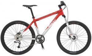 Giant XTC 1: A red and silver mountain bike with disc brakes, a front suspension fork, and a sleek frame design.