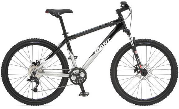 Giant XTC-2: A black and silver mountain bike with large tires and a sturdy frame, featuring a front suspension fork and disc brakes. The bike has "Giant" branding on the frame and includes multiple gears for varied terrain.