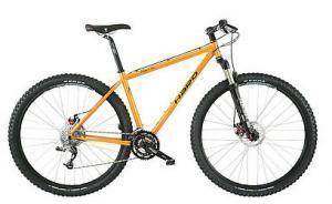 Haro Mary XC: A brightly colored orange mountain bike with a sturdy frame, wide tires, and multiple gears. The bike features front suspension and disc brakes, suitable for off-road terrain.