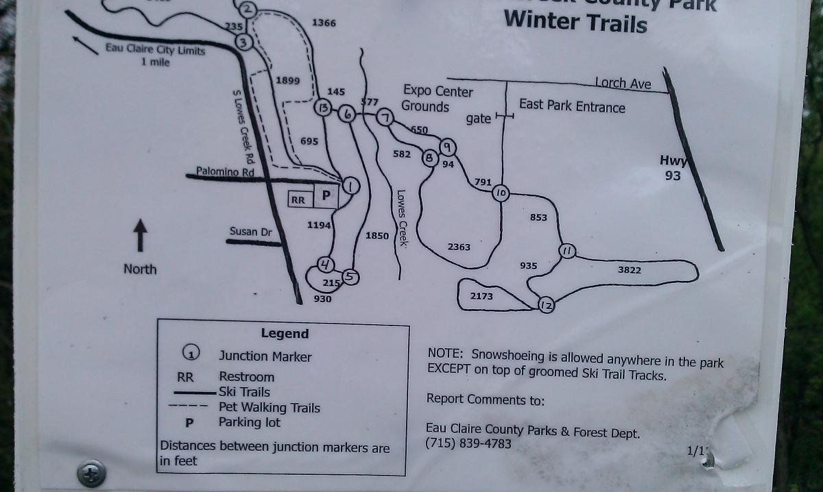 Map of Eau Claire County Park's winter trails, including ski and pet walking trails, restrooms, and junction markers, with noted distances. The map indicates the park layout, key landmarks, and directions, along with a note about snowshoeing regulations. Lowes Creek mountain bike trail.