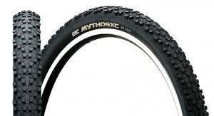 IRC Mythos XC: A pair of mountain bike tires, featuring a knobby tread pattern for enhanced traction. One tire is positioned upright while the other is lying flat, showcasing their black rubber construction and white sidewalls. The brand name "Mythos XC" is prominently displayed on one of the tires.