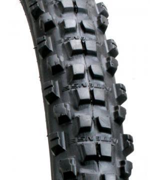 ITS 909: Close-up view of a mountain bike tire featuring a rugged tread pattern, designed for enhanced grip and traction on various terrains. The tire is predominantly black with raised knobs and lettering visible on the sidewall.