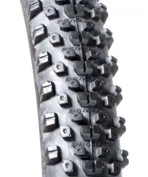 ITS System 4: Close-up view of a rugged bicycle tire featuring a pattern of pronounced, angular tread blocks designed for enhanced grip and traction on off-road surfaces.