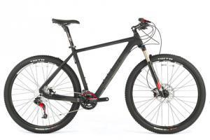Ibex Maroc 29: A sleek black mountain bike with a lightweight frame, front suspension, and rugged tires, positioned against a plain white background.