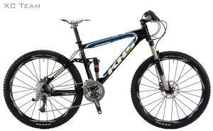 KHS XC Team: A black and blue mountain bike with a lightweight frame, wide tires, and a dual suspension system, featuring Shimano gear components. The bike is displayed against a plain white background.