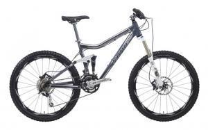 A modern mountain bicycle with a sleek silver and black design, featuring wide tires and disc brakes, suited for off-road trails.