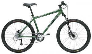 Kona Blast: Alt tag: A green mountain bike with a lightweight frame, wide tires, and front suspension, showcasing a modern design suitable for off-road cycling.