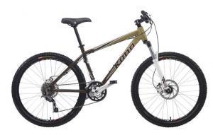 Kona Cinder Cone: A mountain bike with a bronze and black frame, front suspension, and disc brakes. The bike features a single gear in the front and multiple gears in the rear, designed for off-road terrain.