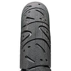 Maxxis Hookworm: Close-up view of a motorcycle tire, showcasing its tread pattern and rubber texture. The design features grooves and ridges for improved grip and handling on various surfaces.