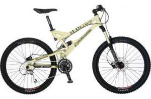 Mongoose Teocali Elite: A yellow mountain bike with wide black tires, front suspension, and a gear mechanism visible on the side. The bike features a sporty design, suitable for off-road trails.