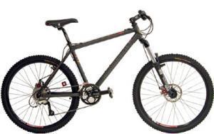 Motobecane Fantom Comp: A black mountain bike with red accents, featuring a sturdy frame, thick tires, and dual suspension, displayed upright against a plain background.