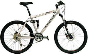 Motobecane Fantom Trail DS: Mountain bike with a silver frame, black tires, and front suspension, featuring various gears and a sleek design.