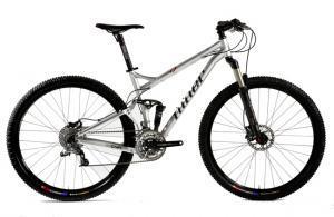 Niner RIP 9: Mountain bike with a silver frame, front suspension, and large, rugged tires, positioned against a plain background.