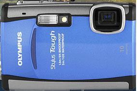 Olympus Stylus Tough 6000: A close-up of an Olympus Stylus Tough camera, featuring a bright blue exterior with a rugged design, a lens, and built-in flash. The camera is noted for being waterproof and shockproof.