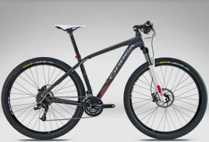 Orbea Alma 29er H70 2012: A sleek, modern mountain bike with a carbon frame, featuring front suspension, disc brakes, and wide tires, set against a neutral background.