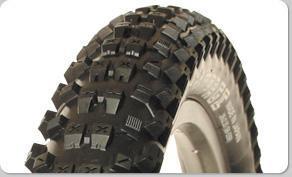 Panaracer Rampage 26: Close-up view of a motorcycle tire with an aggressive tread pattern, designed for off-road conditions.