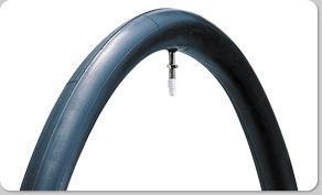 Panaracer Super Tube: A close-up image of a black bicycle inner tube displayed in an arched position, featuring a valve at the top for inflation. The background is white, emphasizing the tire’s shape and details.