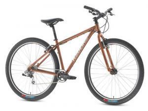 Redline D440 29er: A brown mountain bike with a sturdy frame, flat handlebars, and knobby tires, positioned against a plain background.