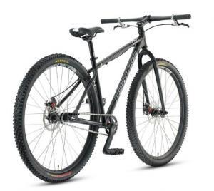 Redline Monocog Flight 29er: Alt text: A black mountain bike with thick tires, a lightweight frame, and a simple gear setup, positioned at an angle to showcase its design and features.