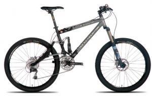 Rocky Mountain ETSX-70: Mountain bike with a black and gray frame, equipped with front suspension, disc brakes, and wide tires, positioned against a white background.